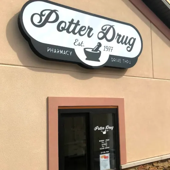 rochester-s Potter Drug pharmacy sign above entrance door on a beige building exterior.